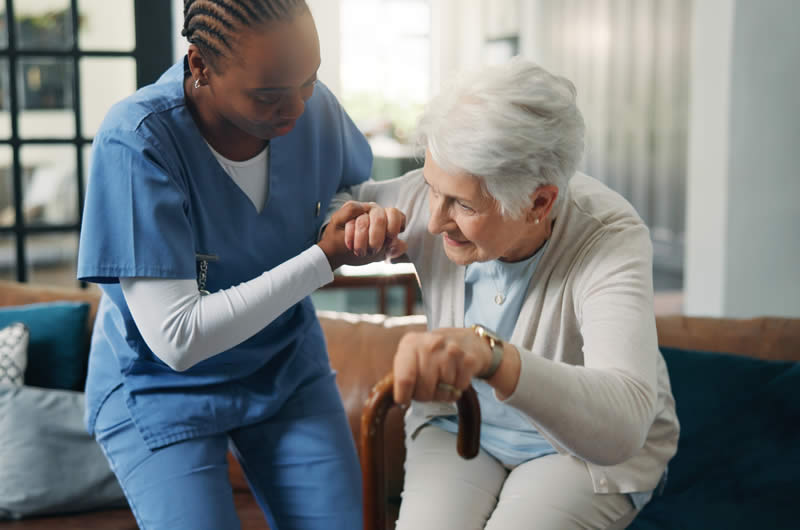 Caregiver helping lift an older person